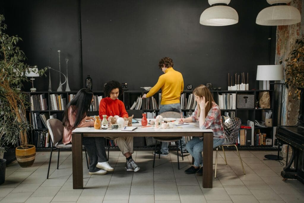 Project manager qualities demonstrated by team collaboration in a creative workspace