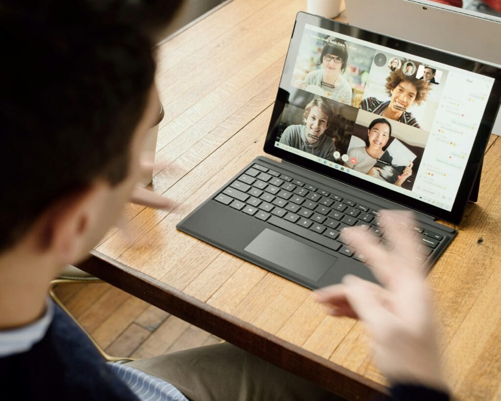 A professional engaging in a video conference with nearshore remote teams on a tablet, showcasing effective nearshore collaboration.