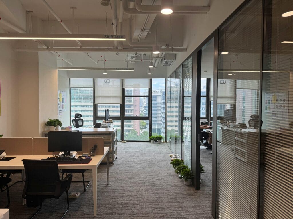 Modern office workspace with computers and natural light, representing sustainable IT and growing cybersecurity demand in European tech environments